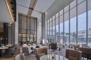 a rendering of a restaurant with tables and chairs at Fuzhou Marriott Hotel Riverside in Fuzhou