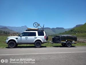 a white jeep with a bike on the back at Isikhoma-Khoma in Hilton