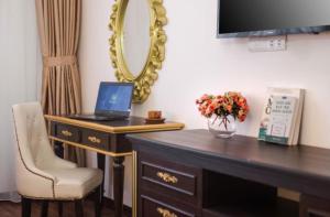 a desk with a laptop on it next to a mirror at Xaysomboun Hotel & SPA in Vientiane