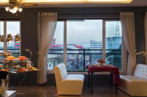 a living room with a large window with a view at Xaysomboun Hotel & SPA in Vientiane