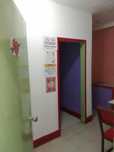 a room with a colorful door with a sign on it at WJV INN Cordova in Cebu City