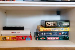 a stack of books sitting on a shelf at B14-Exclusive apartment&parking in Timişoara