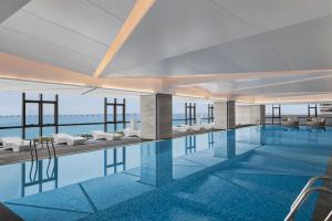 a rendering of a swimming pool with a view of the ocean at Courtyard by Marriott Xiamen in Xiamen