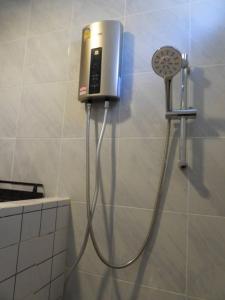 a shower in a bathroom with a phone on the wall at private khaoyai in Mu Si