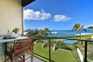 a balcony with a table and a view of the ocean at Napili Point C40 in Kahana