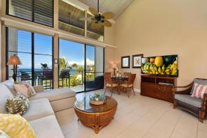 a living room with a couch and a table at Napili Point C40 in Kahana