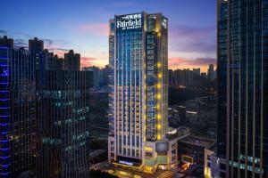 a tall building with a sign on it in a city at Fairfield by Marriott Guiyang Guanshanhu in Guiyang