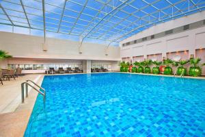 a large swimming pool with a glass ceiling at Sheraton Chengdu Lido Hotel in Chengdu