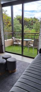 a room with a large window with chairs and a table at Zimbali Suites 613 - 1 Bedroom in Ballito