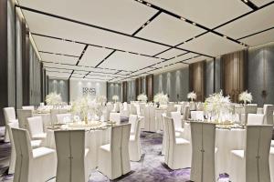 a banquet hall with white tables and white chairs at Four Points by Sheraton Suzhou, Wuzhong in Suzhou