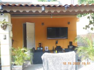 a house with a flat screen tv on a wall at Gustave Vacation House in Port-au-Prince