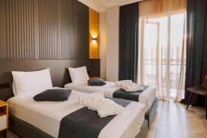 a hotel room with two beds with towels on them at Bel Mare Boutique Hotel in Batumi +41 photos