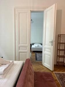 a bedroom with a bed and a open door at Centrally-Located authentic apartment in Vienna