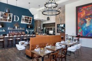 a restaurant with tables and chairs and a bar at Residence Inn by Marriott Stamford Downtown in Stamford