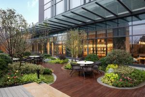 a courtyard with tables and chairs in a building at Courtyard by Marriott Suzhou Mudu in Suzhou