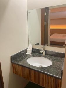 a bathroom with a sink and a mirror at Soleo Inn in Baguio