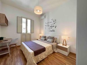 a bedroom with a bed and a table and a desk at Lella suite home in Lecce