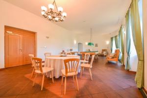 a dining room with a table and chairs at Kaštieľ Sokoľany in Sokoľany