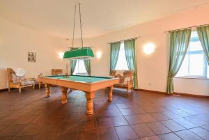 a living room with a pool table in it at Kaštieľ Sokoľany in Sokoľany