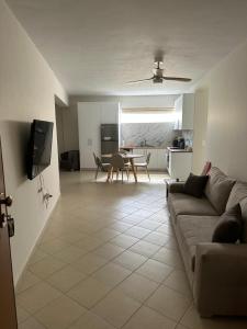 a living room with a couch and a table at Home 4U apt1, just 7km from airport in Markopoulo