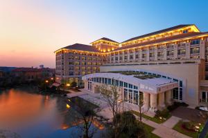 a hotel with a large building next to a body of water at Sheraton Changzhou Wujin Hotel in Changzhou