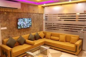 a living room with a couch and a tv at Hotel JMB in Jodhpur