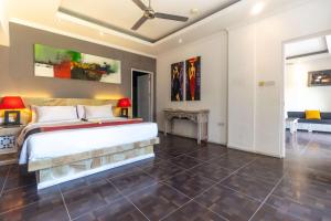 a bedroom with a large bed in a room at Aleesha Villas and Suites in Sanur