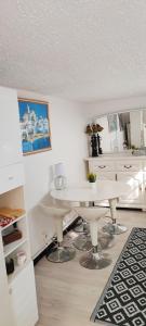 a kitchen with a white table in a room at Maison charmante à Peille + jardin in Peille