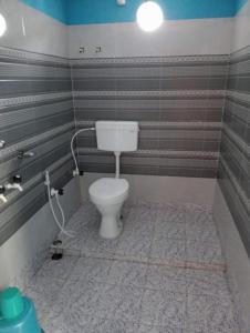 baño con aseo blanco en una habitación en Poddar Retreat Managed by Wheels And Wings, en Dām Dim