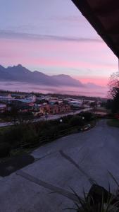 a view of a city with a sunset in the background at Casa Castegner - Rooms in Seren del Grappa