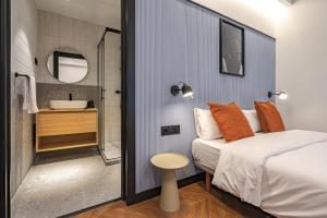 1 dormitorio con 1 cama y baño con lavamanos en Style Suites by Olala Homes, en Madrid