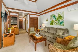a living room with a couch and a table at KP41 1Br Poipu Condo with AC, Steps to the Beach in Koloa