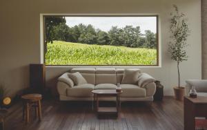 a living room with a couch and a large window at Uon in Gyeongju