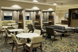 a waiting room with tables and chairs at Residence Inn by Marriott Columbia Northwest/Harbison in Columbia