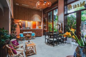 a restaurant with tables and chairs in a room at LAM Apartment & Hotel Danang - Quiet Living in Modern Comfort in Danang