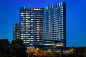 a tall building with aania on the top of it at Hangzhou Marriott Hotel Qianjiang in Hangzhou