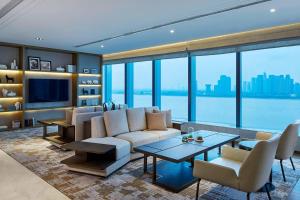 a living room with a couch and a table at Hangzhou Marriott Hotel Qianjiang in Hangzhou