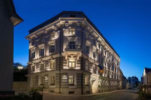 a large white building with lights on at Hotel Telegraaf, Autograph Collection in Tallinn