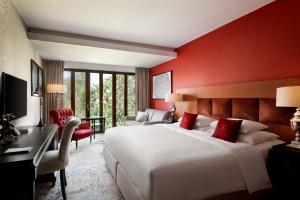 a bedroom with a large white bed and red walls at Hotel Telegraaf, Autograph Collection in Tallinn