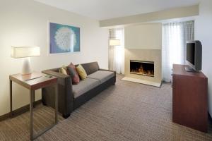 uma sala de estar com um sofá e uma lareira em Residence Inn Indianapolis Airport em Indianápolis