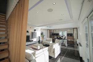 a living room with white furniture at Smart Villa Olive 