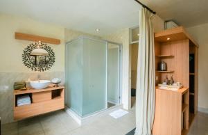 a bathroom with a glass shower and a sink at Bucu View Resort in Ubud