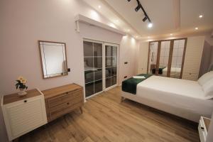 a bedroom with a large white bed and a mirror at Smart Villa Olive 