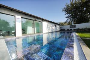 a swimming pool in the backyard of a house at Smart Villa Olive 