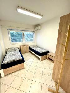 - 2 lits dans une chambre avec 2 fenêtres dans l'établissement Ubytování Pardubice Trnová, à Pardubice