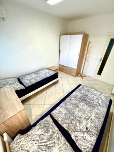 a room with two beds and a mirror at Ubytování Pardubice Trnová in Pardubice