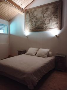 Schlafzimmer mit einem Bett mit Wandgemälde in der Unterkunft LES CHAMBRES DE LIANE in Cerdon