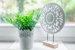 a mirror sitting next to a vase with a plant at City Park Apartments - #11-12 - Apartments mit Ambiente am Park in Leipzig