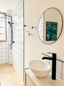 a bathroom with a white sink and a mirror at Appart 2 chambres HYPERCENTRE de Berck-Plage - WIFI in Berck-sur-Mer