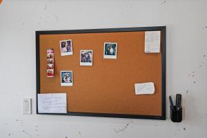 a bulletin board with pictures on a wall at Eye-Opening And Ultra-Secure Luxury Hollywood Condo in Los Angeles